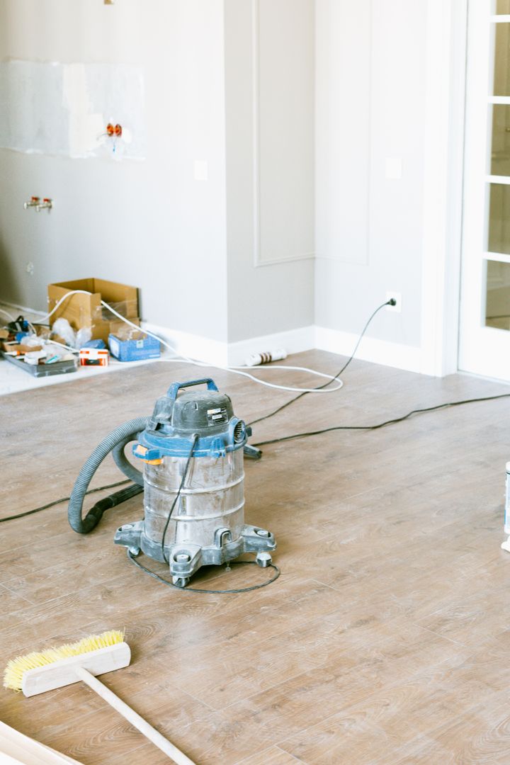 Industrial vacuum and brush in a room after renovation work
