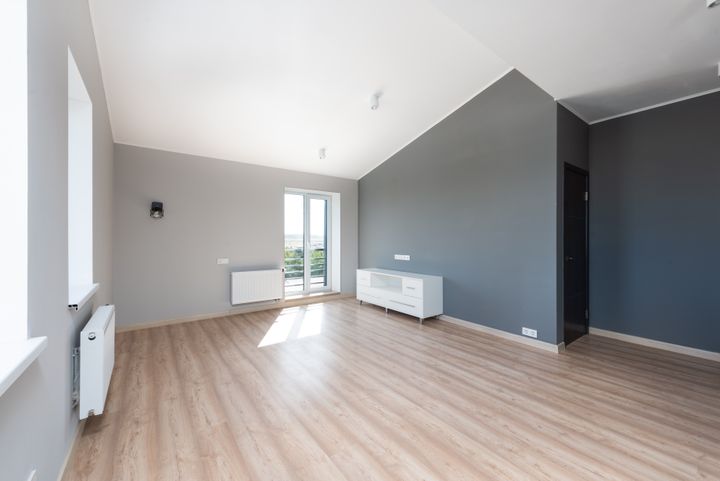 Clean, empty unfurnished apartment with wooden floor ready for new tenants