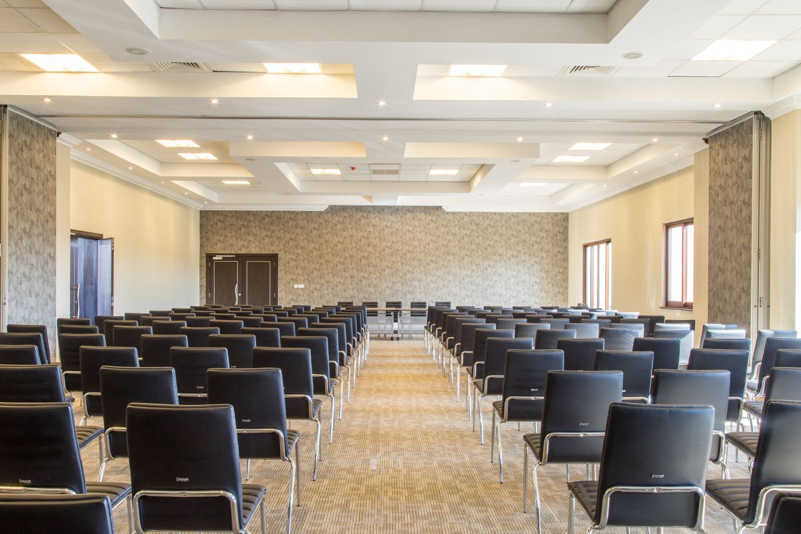 Empty conference hall with rows of chairs ready for an event
