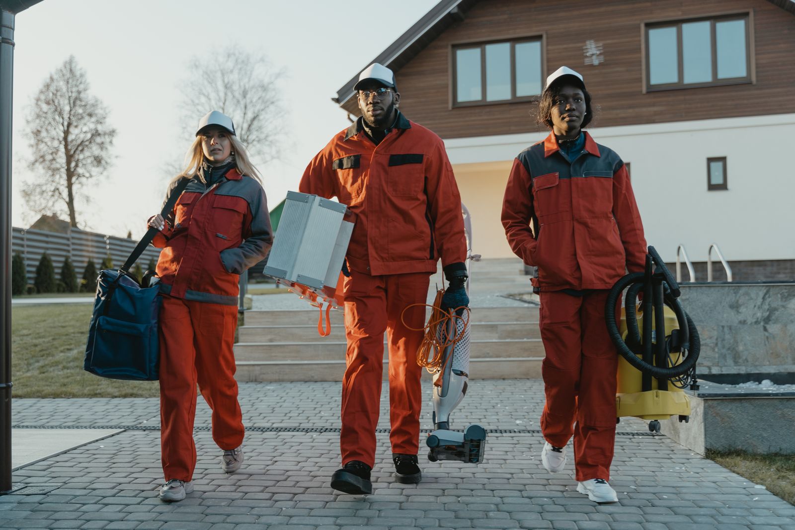 Professional cleaning team walking to a job carrying equipment